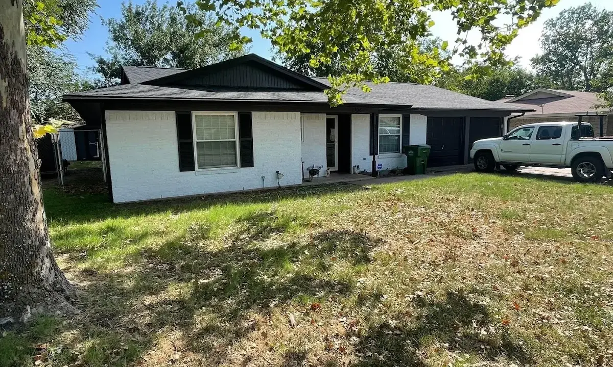Professional roofing crew working on a residential roof in Concord